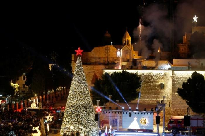 Fireworks explode during a Christmas tree lighting ceremony outside the Church of the Nativity in the West Bank town of Bethlehem.