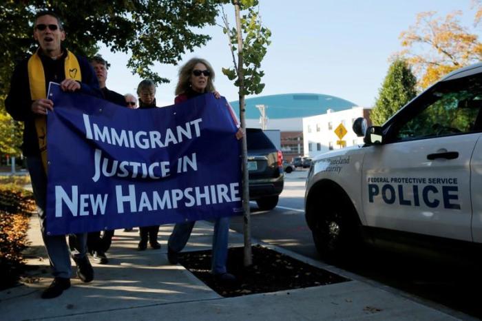 Demonstrators hold an 'Interfaith Prayer Vigil for Immigrant Justice' outside the federal building, where ethnic Chinese Christians who fled Indonesia after wide scale rioting decades ago and overstayed their visas in the U.S. must check-in with ICE, in Manchester, New Hampshire, U.S. on October 13, 2017.