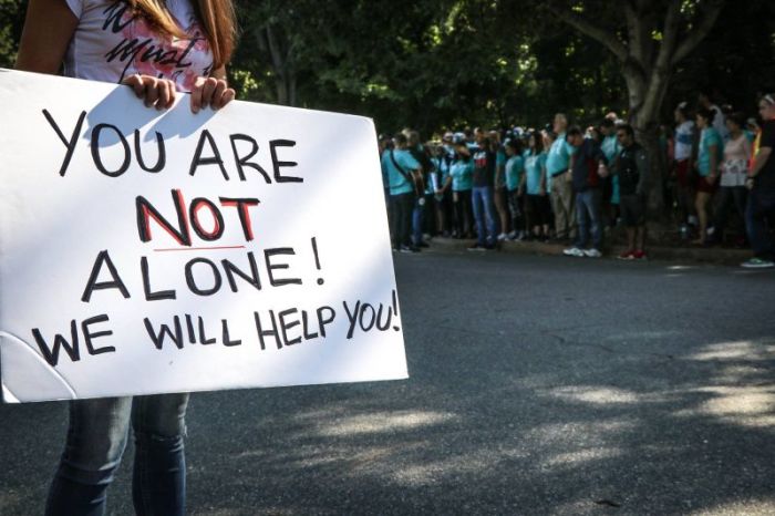 A demonstrator holds up a sign while participating in a Love Live Charlotte prayer walk outside of A Preferred Women's Health Center in Charlotte, North Carolina in this undated photo posted to Facebook on Sept. 11, 2017.