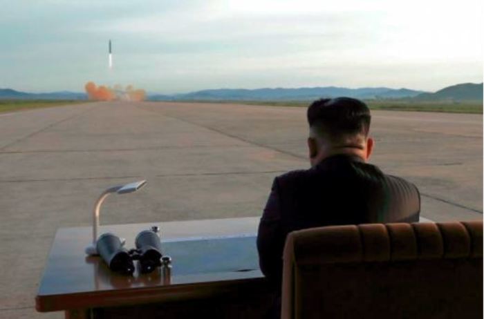North Korea's Kim Jong-un watches as they fire a new and improved nuclear missile.