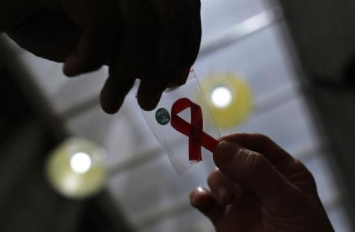 A nurse from Sao Paolo, Brazil hands out a red ribbon in time for the 2017 World AIDS Day celebration.