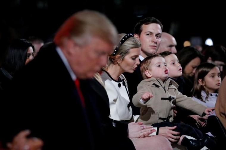 White House senior advisor Jared Kushner, seated with his wife White House senior advisor Ivanka Trump and their children, looks over at President Donald Trump as he bows his head during the prayer in Washington, D.C. November 30, 2017.