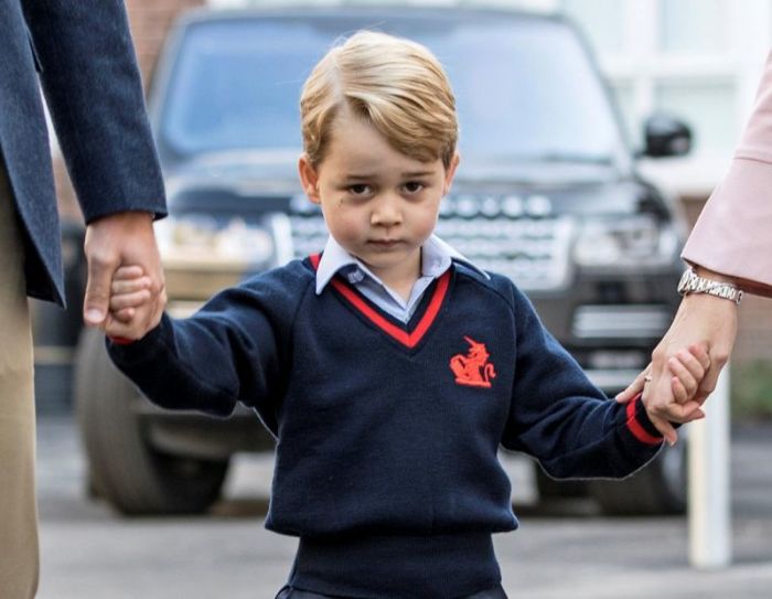Prince George holds his father Britain's Prince William's hand as he arrives on his first day of school at Thomas's school in Battersea, London, September 7, 2017.