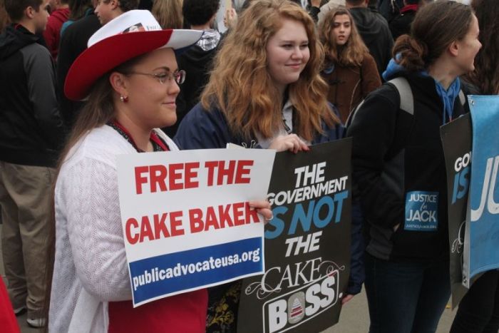 Suppoters of Jack Phillips hold signs in from of the United States Supreme Court as arguments for Masterpiece Cakeshop v. Colorado Civil Rights Commission are heard inside on December 5, 2017.