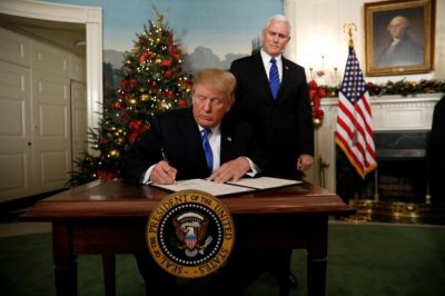 With Vice Pence Mike Pence looking on, U.S. President Donald Trump signs an executive order after he announced the U.S. would Jerusalem as the capital of Israel, in the Diplomatic Reception Room of the White House in Washington, U.S., December 6, 2017.