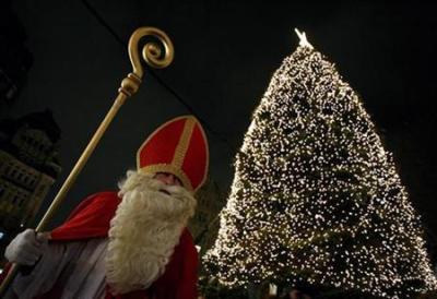 A man dressed as Saint Nicholas stands beside an illuminated Christmas tree in the city center of Hamburg December 6, 2008.