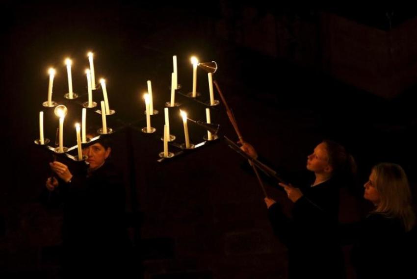 Candles are lit as Salisbury Cathedral celebrates the beginning of Advent with a candle lit service and procession, "From Darkness to Light", in Salisbury, Britain November 27, 2015.