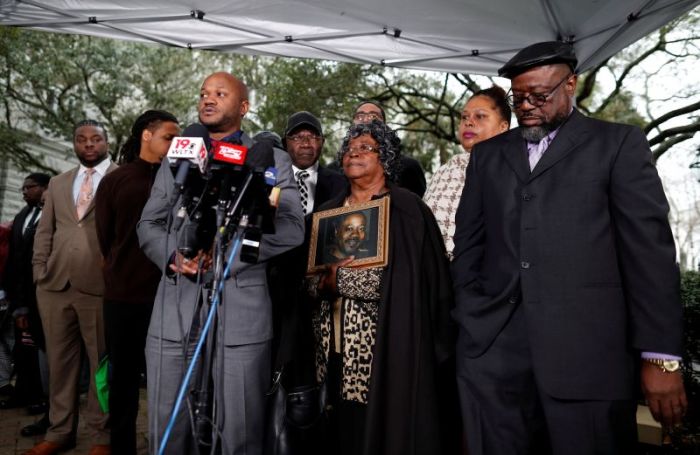 Scott family attorney Chris Stewart speaks at a news conference as Judy Scott holds a photo of her son Walter Scott in Charleston, South Carolina, December 7, 2017.