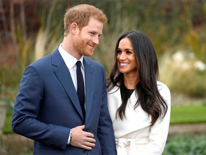 Prince Harry poses with Meghan Markle in the Sunken Garden of Kensington Palace.