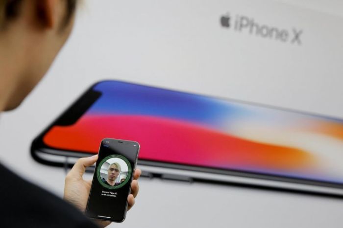 An attendee uses the Face ID function on the new iPhone X during a presentation for the media in Beijing, China October 31, 2017.