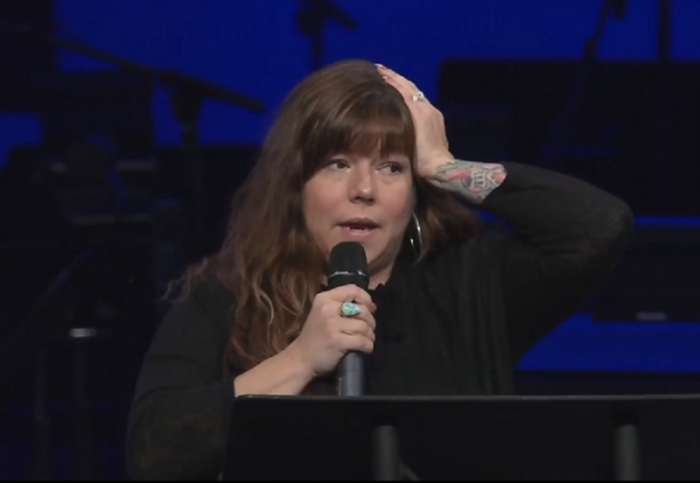 Chastity Watts holds her head as she suffers a stroke while giving her testimony at Abba's House in Chattanooga, Tennessee on November 19, 2017.