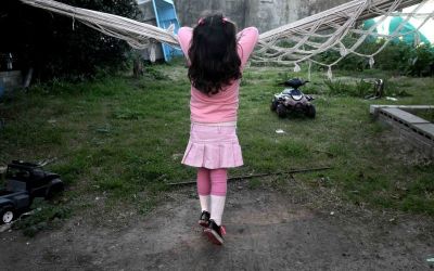 Lulu, a transgender girl, leans on a hammock at her home in Buenos Aires.