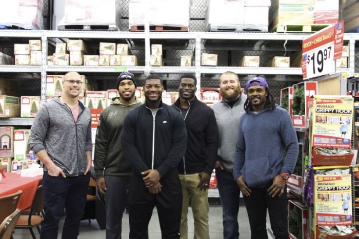 Benjamin Watson and his Baltimore Ravens teammates participate in Watson's annual Big BENefit event at a Walmart in Randallstown, Maryland on Dec. 11, 2017.