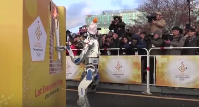 HUBO, South Korea's first humanoid robot, is carrying an Olympic torch while performing a disaster relief exercise in Pyeongchang, South Korea, on November 12, 2017.