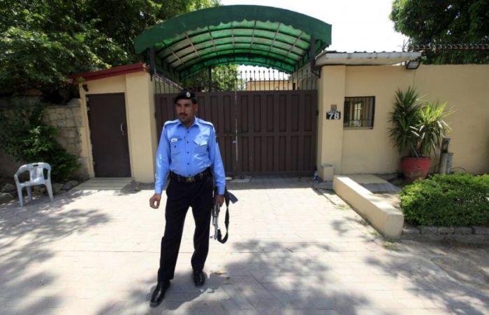 A policeman stands guard outside the Save the Children charity's office in Islamabad, Pakistan, June 12, 2015.