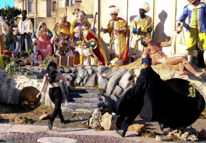 A topless activist from the feminist group Femen tried to snatch the statue of the baby Jesus from the Nativity scene in St. Peter's Square at the Vatican, but was stopped by police as she grabbed it, December 25, 2017.