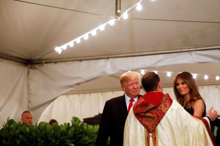 U.S. President Donald Trump and First Lady Melania Trump arrive for church service at The Church of Bethesda-By-The sea in Palm Beach, Florida on Dec. 24, 2017.