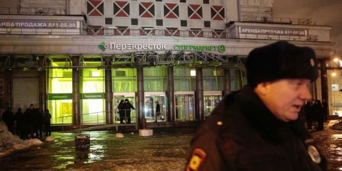 A policeman stands guard near a supermarket after an explosion in St Petersburg, Russia, December 27, 2017.