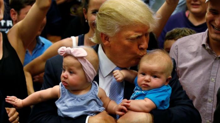 Republican presidential nominee Donald Trump kisses a baby at a campaign rally in Colorado Springs, Colorado in July 2016.