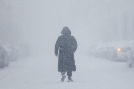 Credit : A woman walks down the street during a blizzard in Long Beach, New York in this undated photo.