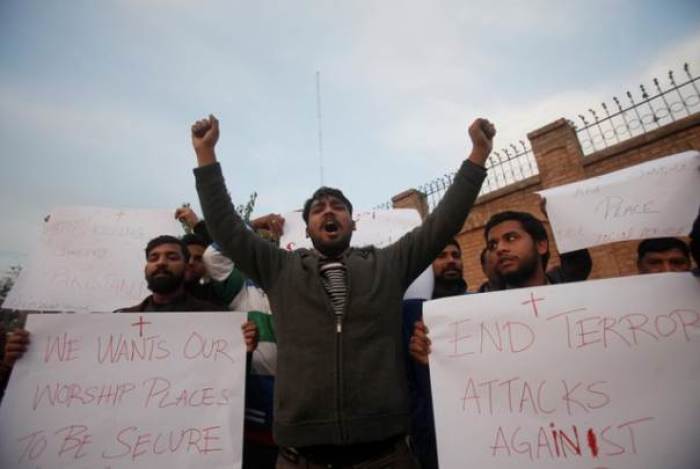 Christians hold placards as they chant slogans to condemn Quetta Church attack during a protest in Peshawar, Pakistan December 17, 2017.