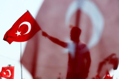 <strong>A man waves Turkey's national flag during the Democracy and Martyrs Rally, organized by Turkish President Tayyip Erdogan, November 12, 2016.</strong>