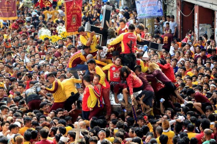 Devotees jostle one another as they try to touch the Black Nazarene replica during an annual procession in Quiapo, Manila, Philippines, on January 7, 2018.