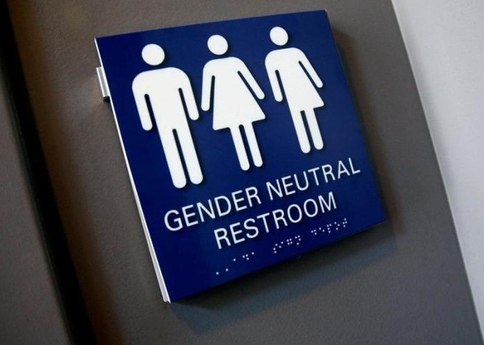 A gender-neutral restroom sign is seen placed outside a restroom in Philadelphia, Pennsylvania, on June 9, 2016.