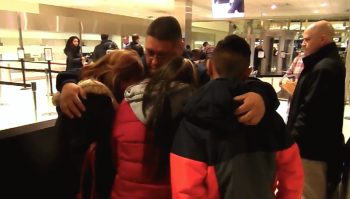Jorge Garcia, 39, hugs his heartbroken family as ICE agents stand nearby at the Detroit airport. Garcia was deported to Mexico.