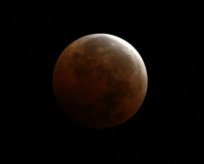 A total lunar eclipse, also known as a 'blood moon', is pictured from Encinitas, California, October 8, 2014.