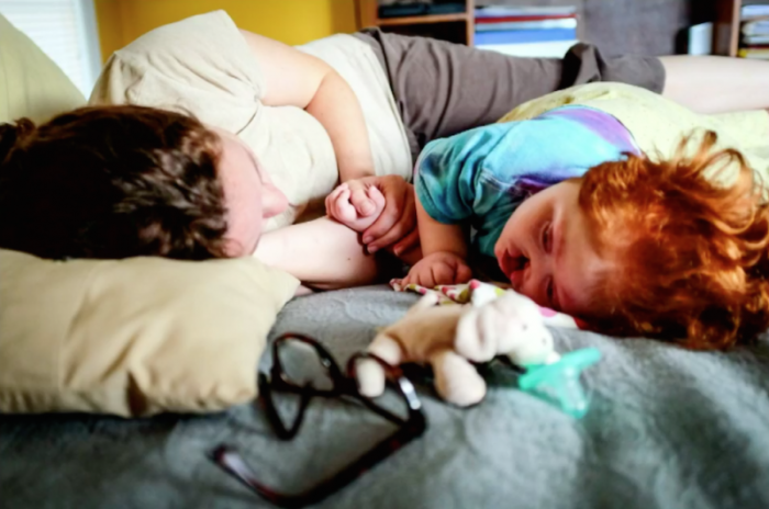 Ruth Brown lies down with her daughter, Pearl, who suffers from a rare disorder called Alobar holoprosencephaly.