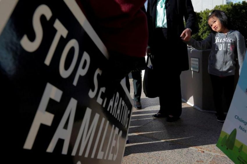 Demonstrators holding an "Interfaith Prayer Vigil for Immigrant Justice" talk to ethnic Chinese Christians who fled Indonesia after wide scale rioting decades ago and overstayed their visas in the U.S., following their family meeting, including their five year-old daughter (R), with ICE, in Manchester, New Hampshire, U.S., October 13, 2017.