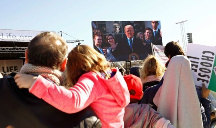 Particpants watch as U.S. President Donald Trump speaks by satellite from the nearby White House to attendees of the March for Life anti-abortion rally in Washington, U.S. January 19, 2018.