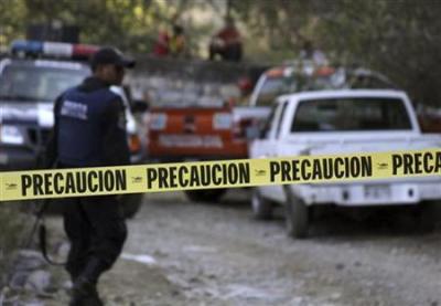 Rescue personnel inspect a ventilation shaft of an abandoned mine in a cordoned off crime scene in Taxco May 30, 2010.
