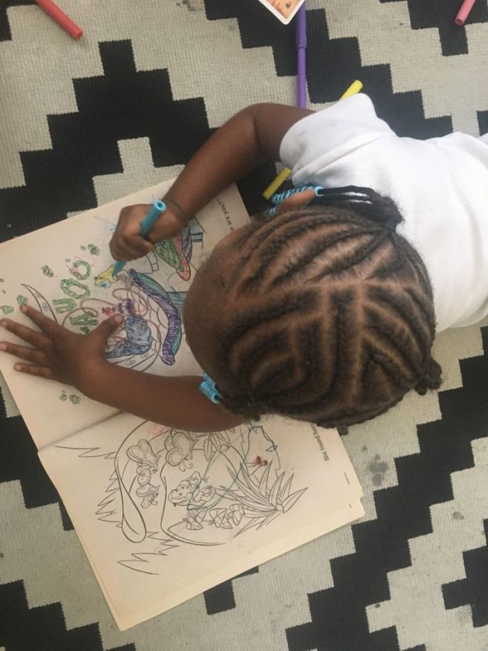 Child drawing in a coloring book in an undated photo provided by Saving Innocence.