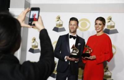 Matt Crocker and Brooke Fraser pose with their Grammys for Best Contemporary Christian Music Performance/Song for 'What a Beautiful Name,' Jan. 28, 2018.