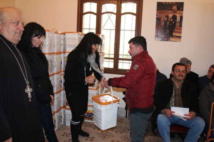 The Iraqi Christian Relief Council distributes buckets of food to Iraqi Christian refugees in Amman, Jordan, in January 2018. 