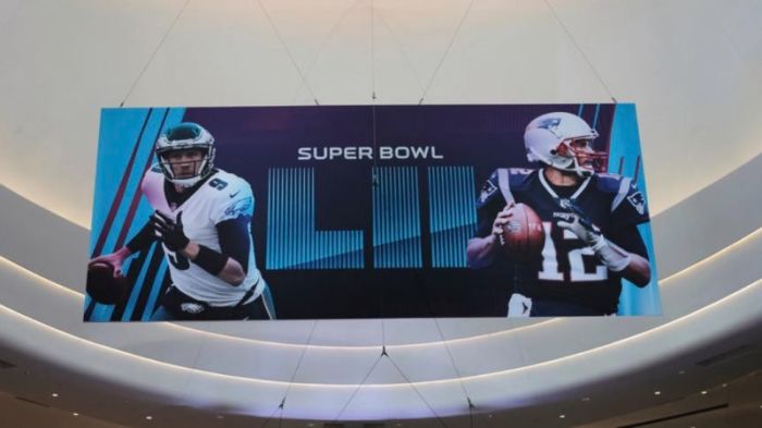 A Super Bowl promotional banner showing Philadelphia Eagles quarterback Nick Foles and New England Patriots quarterback Tom Brady hangs in an atrium at the Mall of America in Minneapolis, Minnesota, U.S.