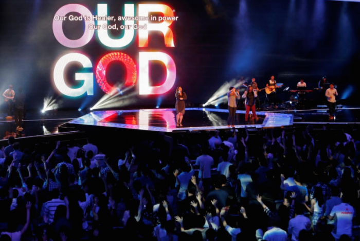 Worshipers attend a church service at the City Harvest Church in Singapore March 1, 2014.