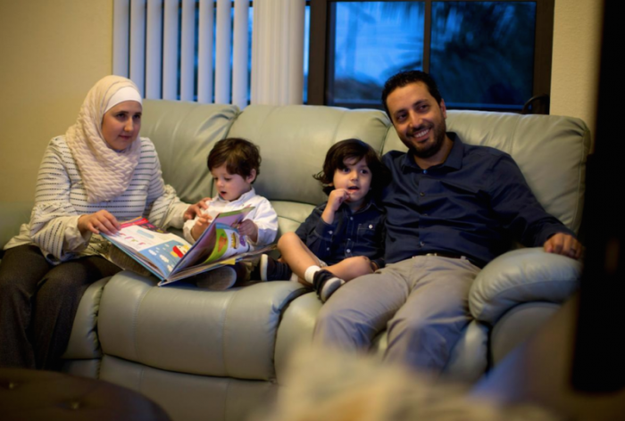 Temporary Protected Status (TPS) holders Mohammad Alala, his wife Dania, both from Syria and their two U.S. born children Taim and Amr sit on the sofa in their home in Miramar, Florida, U.S., January 24, 2018.