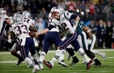 New England Patriots Tom Brady hands the ball to Dion Lewis at the Super Bowl LII on Feb. 4, 2017 at the U.S. Bank Stadium, Minneapolis, Minnesota.
