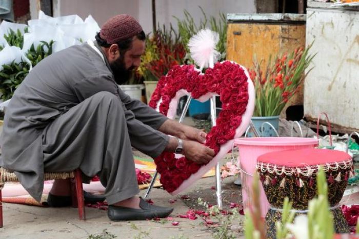 A man arranges a heart-shaped bouquet at a flower market in Islamabad, Pakistan February 14, 2017.