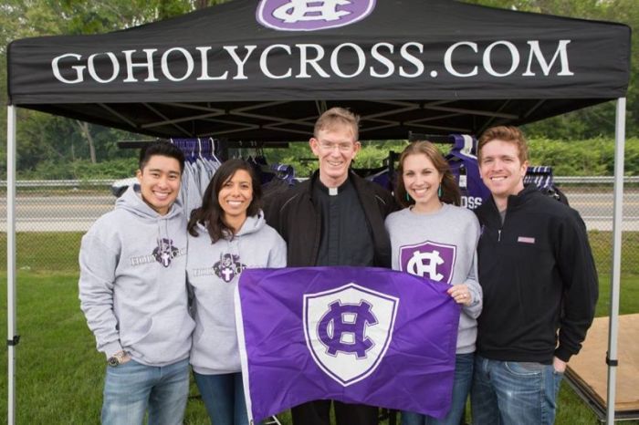College of the Holy Cross president, Rev. Philip L. Boroughs (C), and students.