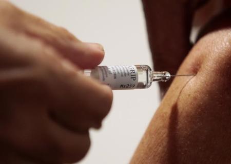 A nurse vaccinates a patient as part of the start of the seasonal influenza vaccination campaign in Nice, southeastern France, October 21, 2015.