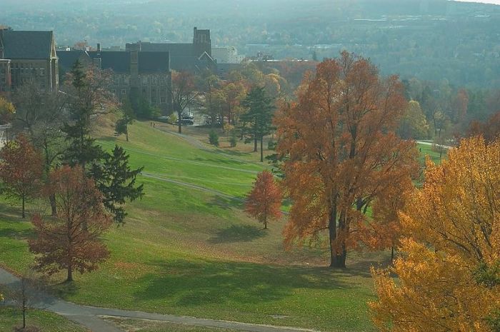 Autumn view of the Library Slope of Cornell University, showing the west ends of Willard Straight Hall, Anabel Taylor Hall, and Myron Taylor Hall, with South Hill and the towers of Ithaca College visible in the background, uploaded in May 2016.