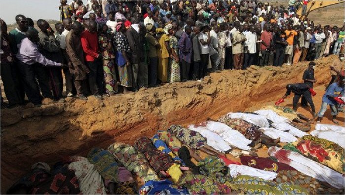 Villagers stood at a mass grave in Dogon Na Hauwa, Nigeria, in 2010.
