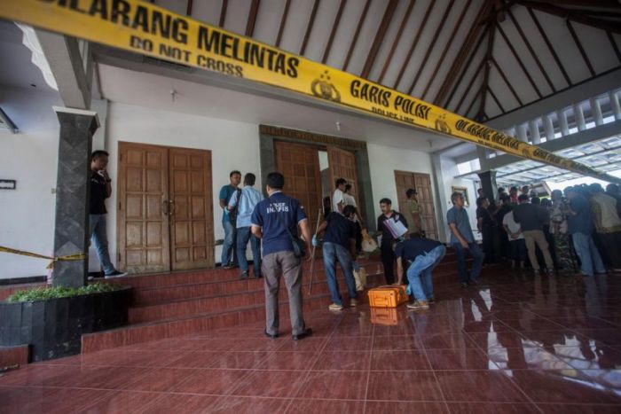 Police are seen outside the Lidwina Catholic Church after a knife-wielding attacker wounded four church-goers in Sleman, Yogyakarta, Indonesia, on February 11, 2018.