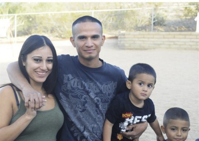 Jesus and Sonia Berrones pose for a photograph with their two sons.