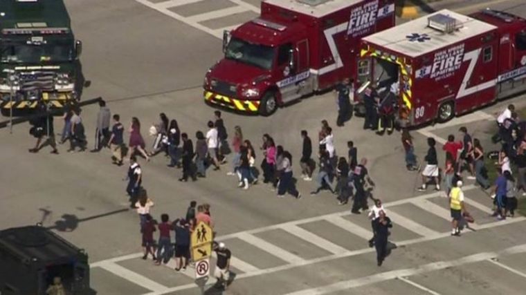 Students are evacuated from Marjory Stoneman Douglas High School during a shooting incident in Parkland, Florida, U.S. February 14, 2018, in a still image from video.