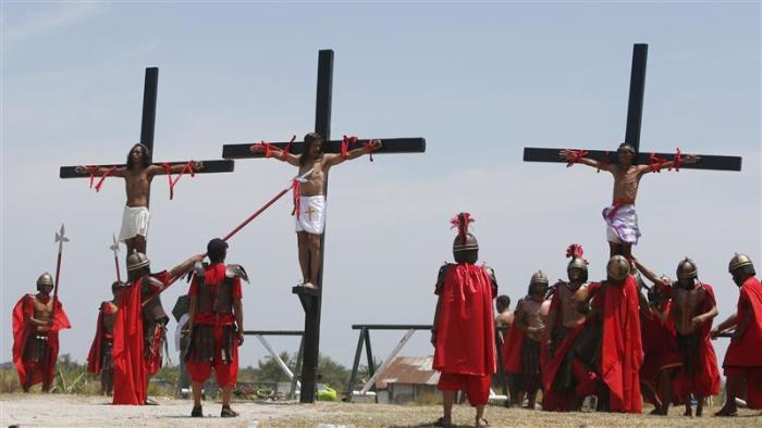 Penitents hang on wooden crosses during the re-enactment of the crucifixion of Jesus Christ on Good Friday in San Fernando, Pampanga in northern Philippines April 18, 2014.